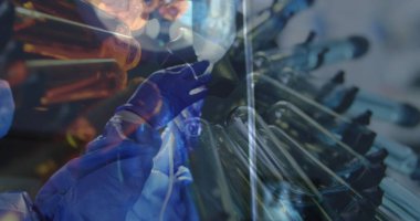 Ameliyathanede yüz maskesi takmış cerrahların üzerinde dönen test tüpleri. tıp ve sağlık hizmetleri konsepti dijital olarak oluşturulmuş imaj.