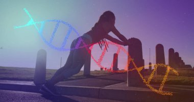 Parkta egzersiz yapan melez bir kadının üzerindeki DNA ipliği. sağlık ve zindelik kavramı dijital olarak oluşturulmuş görüntü.