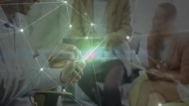 Ofiste tablet kullanan dört profesyonel, dijital ağ örtüsü üzerinden iş verilerini paylaşıyorlar. İşbirliği, takım çalışması, yenilik, teknoloji, iletişim, modernite, veri