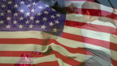 Golf sahasında golf sopası sallayan kadın Amerikan bayrağı ve kırmızı golf çantasıyla pazarlama örtüsü gösteriyor. Atletik, boş zaman, açık hava, canlı, kararlılık, spor, manzara