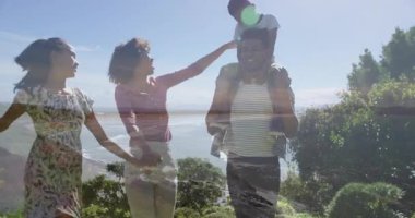 Kıyı uçurumunda ayakta duran aile sağlık grafiği kaplaması ve yüzen kalp ikonu gösteriyor. Manzara, mutluluk, macera, birliktelik, açık hava, bağlantı, canlı