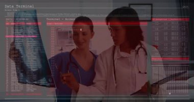Sağlık ofisindeki kadın tıp uzmanları monitördeki şifrelenmiş verileri inceliyor. Sağlık, siber güvenlik, teknoloji, işbirliği, analiz, dijital, yenilik