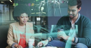 Screens with data processing against diverse male and female office colleagues discussing at office. business technology concept