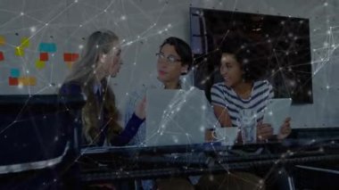 Meslektaşlar iş stratejisini dizüstü bilgisayar, tablet ve animasyon teknolojisi ağlarıyla tartışıyor. İşbirliği, yenilik, teknoloji, iletişim, beyin fırtınası, dijital, profesyonel