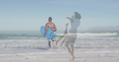 Babası kızını plajda taşıyor. Canlandırılmış kalp ikonu ve sağlık verileri üst üste geliyor. Aile, okyanus, boş zaman, açık hava, rahatlama, macera, güneşli