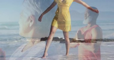 Sahilde dans eden kadın, okyanusa bakan erkek, grafik tasarımı için birleşen dalgalar. Canlı, dinginlik, ahenk, yansıtıcı, zarafet, açık hava, derin derin düşünme.