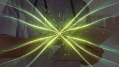 Klinikte steteskopla eğilen erkek doktor canlandırılmış yeşil ışık demetleri ve parıltılar gösteriyor. Sağlık, tıp, yenilik, teknoloji, profesyonellik, sağlık, teşhis