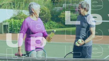 Tenis kortunda raket tutan yaşlı çift su şişesi taşıyor. Aktif giysi, sağlık, canlılık, açık hava, rahatlık, refah, esneklik