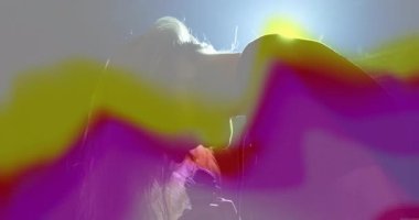 Kadın sahnede şarkı söylüyor ve mikrofona yaslanıyor, animasyon müzik dalgaları ve lens fişekleri ile. Performans, sahne, ışıklandırma, konser, atmosfer, ışıklar, müzik