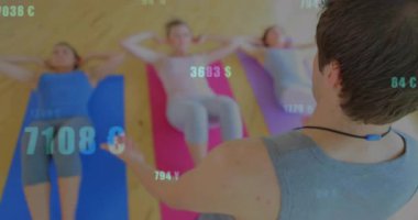 Erkek eğitmen, spor salonunda, yüzen numaraları ve para birimi simgelerini gösteren, mekik çeken kadınlara rehberlik ediyor. Zindelik, sağlık, motivasyon, veri, analiz, eğitim, sağlık