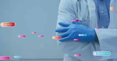 Doktor laboratuvar önlüğü ve mavi eldiven giyiyor, kollarını kavuşturuyor, sağlık hizmetleri için uyarı simgeleri gösteriyor. Tıbbi, sağlık, fütüristik, veri, teknoloji, profesyonel, klinik