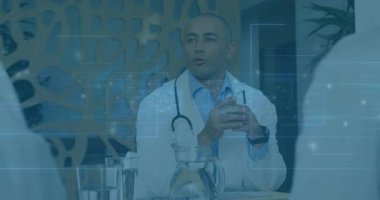 Tıbbi ofiste el kol hareketi yapan, dijital veri örtüleri gösteren ve steteskop takan bir erkek doktor. Profesyonel, sağlık, danışma, teknoloji, iletişim, modern, tanı