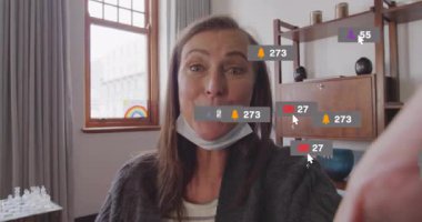 Olgun bir kadın, ana ofiste pazarlama vlog 'u yaratıyor, yüzen sosyal medya simgeleriyle etkileşime geçiyor. Yaşam tarzı, nüfuz eden, dijital, modern, bağlılık, teknoloji, konfor