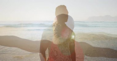 Baba ve oğul kumsalda ayakta duruyor. Canlandırılmış kalp ikonu ve çizelgesi ile sağlık temasını gösteriyorlar. Zenginlik, bağlantı, uyum, dinginlik, canlılık, açık hava, manzara