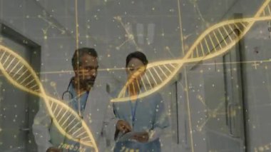 Erkek doktor ve kadın hemşire koridorda yürüyorlar. İçinde DNA holografik ipliklerin bulunduğu tableti inceliyorlar. Tıbbi, sağlık, bilim, teknoloji, araştırma, yenilik, teşhis