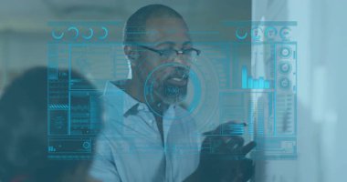 Kıdemli veri analisti, teknik ofisteki holografik arayüzle etkileşimde, mavi çizelgeleri gösteriyor. Teknoloji, veri görselleştirme, dijital arayüz, yenilik, kurumsal, profesyonel, fütürist