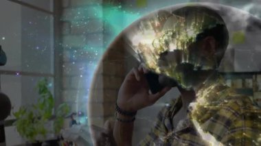 Teknoloji ofisinde akıllı telefondan konuşan gözlüklü bir adam hologram küreyi veri için gösteriyor. Profesyonel, yenilik, modern, bağlantı, teknoloji, işbirliği, kentsel