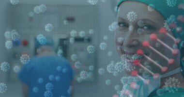 Ameliyat odasında önlük ve maske takan gülümseyen bir cerrah. Monitörler, virüs örtüsü, kopyalama uzayı. Tıbbi, sağlık, klinik, teşhis, kesinlik, teknoloji, takım çalışması