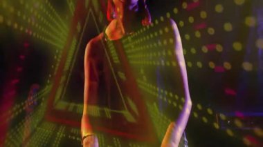 Karanlık stüdyoda duran bir kadın teknolojik markalaşma için yeşil sarı geometri kullanıyor. Soyut, gelecekçilik, multimedya, canlı, sinematik, yenilik, teknoloji