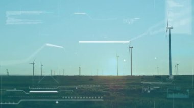 Otlakta dönen rüzgar türbini canlandırılmış HUD arayüzü enerji çıkışını izliyor. Yenilenebilir enerji, sürdürülebilirlik, geleceksel, teknoloji, temiz güç, manzara, dijital arayüz