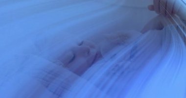 Yatakta uzanmış, mavi çizgili köpek yavrusuna sarılıyor. Ekoseli battaniyenin üzerinde, sağlığın altını çiziyor. Sevimli, masum, rahat, huzur, dostluk, samimi, kaprisli