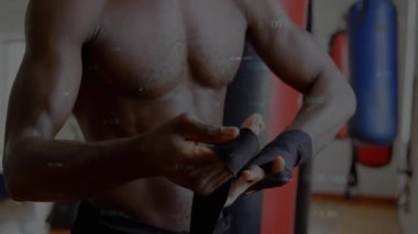 Erkek boksör spor salonunda ellerini topluyor, animasyon performans çizelgesi ve yüzen istatistikler gösteriyor. Sporcu, antrenman, güç, kararlılık, disiplin, fitness, güç