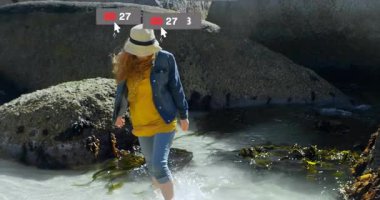 Kadın beline kadar sığ sulara batmış, pazarlama için yüzen sosyal medya ikonları sunuyor. Sahil, sahil, kıyı, doğa, eğlence, yaşam tarzı, hayat dolu.