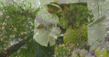 Bahçıvan bahçede süt çocukları suluyor, eğitim için canlandırılmış nem ölçer ve büyüme grafiği gösteriyor. Botanik, bahçıvanlık, açık hava, huzur, bereket, çevre dostu, yaşam tarzı