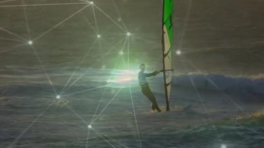 İnsan altın okyanus dalgalarında rüzgar sörfü yapıyor. Parlak ağ düğümleriyle teknoloji bağlantısını gösteriyor. Macera, açık hava, dinamik, enerjik, doğa, keşif, canlı