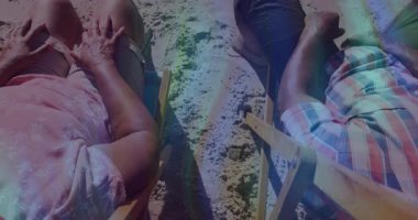 Yaşlı çift kumdaki ahşap plaj sandalyelerine yaslanmış, animasyon seyahat ikonları gösteriyorlar. Plaj, dinlenme, dinlenme, açık hava, güneşli, tatil, huzur