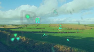 Yeşil tarım arazisi üzerinde yüzen enerji ikonları, temiz enerjiyi vurgulayarak, düz tasarımda. Sürdürülebilirlik, eko-arkadaşlık, yenilenebilir, ekolojik, teknoloji, doğal, yenilikçi