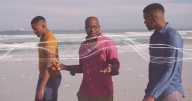 Sahilde yürüyen üç adam, yüzen kalp ikonu ve adım sayım grafiğiyle sağlığı destekliyor. Kıyı şeridi, arkadaşlık, sağlık, açık hava, doğal, arkadaşlık, yaşam tarzı.