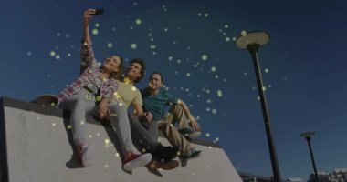 Üç arkadaş meydanda oturmuş, parlayan pazarlama simgeleriyle selfie çekiyorlar. Kentsel, gündelik, hareketli, eğlence, yaşam tarzı, gençlik, açık hava