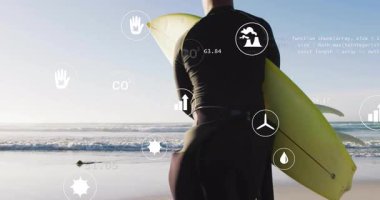 Kumlu sahil şeridinde duran sörfçü adam yüzen haritalar ve kodlarla teknik verileri topluyor. Kıyı şeridi, yenilik, sürdürülebilirlik, teknoloji, çevre dostu, modern, çevrecilik