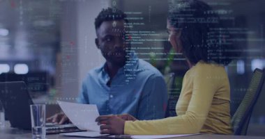 Ofiste doküman ve dizüstü bilgisayar üzerinde işbirliği yapan iki geliştirici yüzen kod ve veri sergiliyorlar. Teknoloji, takım çalışması, yenilik, dijital, iletişim, modernite, analitik