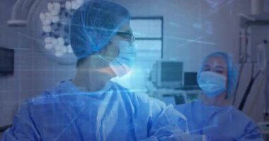 Cerrahlar tıbbi ameliyathanede monitörlerin ve ışıkların üzerinde animasyon veri şebekesi sunuyorlar. Tıbbi, sağlık, klinik, geleceksel, profesyonel, hassas, yenilikçi