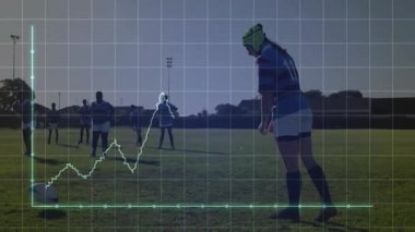 Kadın rugby takımı çimlerin üzerinde diziliyor, kask takan oyuncu performanslarıyla ragbi topunu tekmeliyor. Atletizm, takım çalışması, rekabetçi, açık hava, canlı, enerjik, sportmenlik