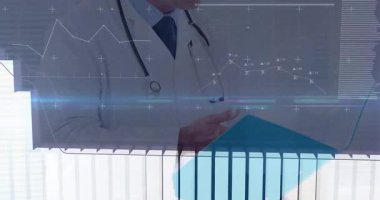 Olgun erkek doktor, klinik uzayda hareketli grafiklerle dijital medikal çizelgeleri analiz ediyor. Sağlık, tanı, teknoloji, analitik, yenilik, profesyonellik, gelecekçilik