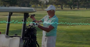 Golf arabası çantasından golf sopası çıkaran yaşlı bir golfçü golf teknolojisi istatistiklerini takip ediyor. Lüks, eğlence, analitik, açık hava, boş zaman, prim, fitness