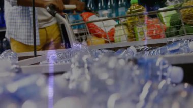 Perakende kasada alışveriş arabasına rehberlik eden bir adam. Üstünde hareketli fiyat etiketleri var. Bakkal, perakende, ticari, modern, tüketici, işlem, yaşam tarzı