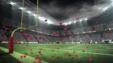 Stadyum sahasında, üzerinde piksel kalpler yüzen Amerikan futbol kaleleri canlandırılıyor. Stadyum, spor, kutlama, rekabet, eğlence, aksiyon, enerji