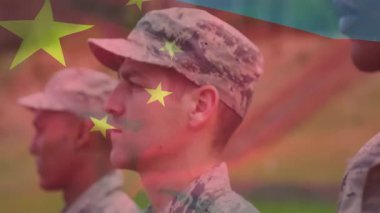 Merkez asker askeri alanda duruyor, bayrak kayıyor, kameraya doğru dönüyor. Vatanseverlik, disiplin, birlik, güç, yiğitlik, dayanıklılık, açık hava