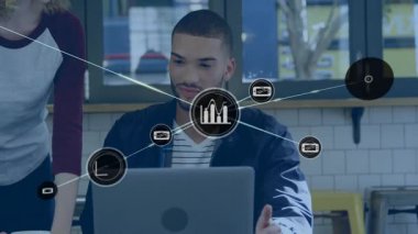 Dizüstü bilgisayarın üstünde görünen düğüm, iş arkadaşları teknolojiyi kullanırken grafik simgelerinin ağ oluşturmasına neden oluyor. İşbirliği, yenilik, takım çalışması, veri analizi, modernite, ağ, parlaklık