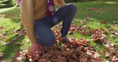 Video of happy caucasian father piggybacking daughter in sunny autumn garden. Family, domestic life and togetherness concept digitally generated video.