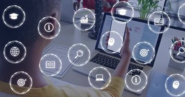 Adam akıllı telefonu kaldırıyor ve iş arkadaşı takım çalışması için yazarken bilgisayardan teknik simgeleri gösteriyor. Teknoloji, işbirliği, yenilik, dijital, çalışma alanı, fütüristik, iletişim