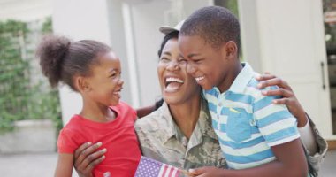 Animation of happy african american soldier mother and children hugging and embracing. family, togetherness, army and american patriotism concept.