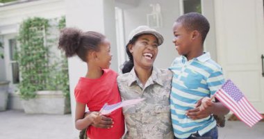Animation of happy african american soldier mother and children hugging and embracing. family, togetherness, army and american patriotism concept.