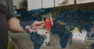 Mavi dünya haritası şekil değiştirirken, makinist dükkan bankında yumruk tokuşturuyor. Sanayi, zanaat, kesinlik, teknoloji, yenilik, mühendislik, üretkenlik