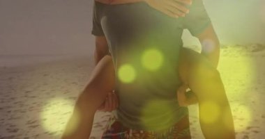 Seyahat gövdesi, kumsalda yürüyen bir çiftin Altın Bokeh aracılığıyla aşkı paylaştığını gösteriyor. Romantizm, arkadaşlık, eğlence, yaz, kaygısız, huzur, yaşam tarzı.