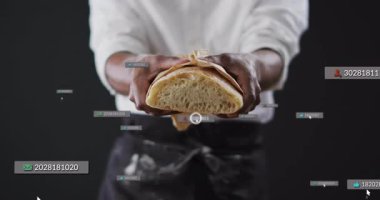 Ekmek tutan adam yörüngedeki ekmeklerin etrafında dönerek süzülen metrik etiketleri başlatarak pazarlama verilerini vurguluyor. Sanatçı, modern, minimalist, dijital, pazarlama, tipografi, ekran